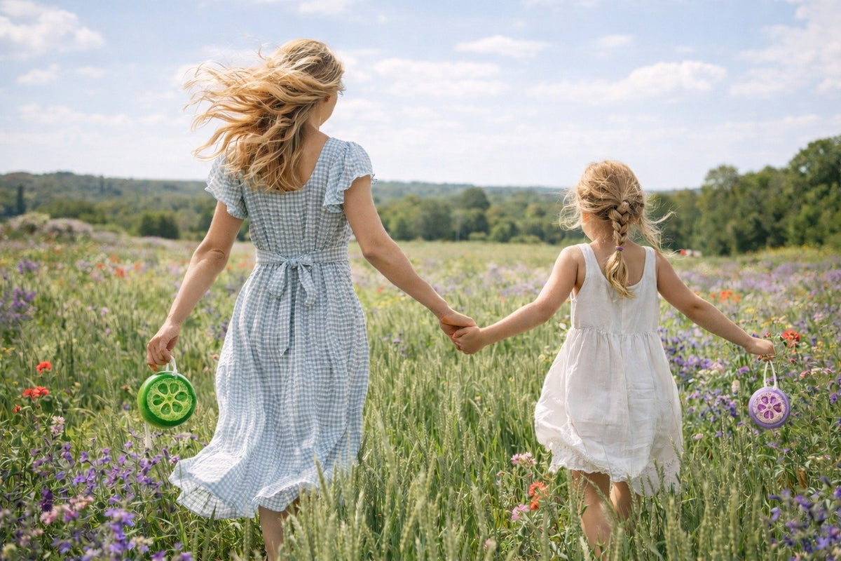 Mother and daughter holding LoofaLuxe loofah soaps in a meadow